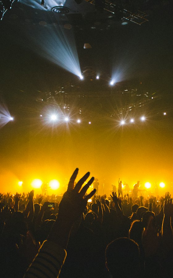 Audience lit gold from the stage