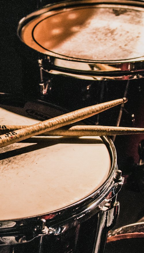 Sticks laid across a snare drum