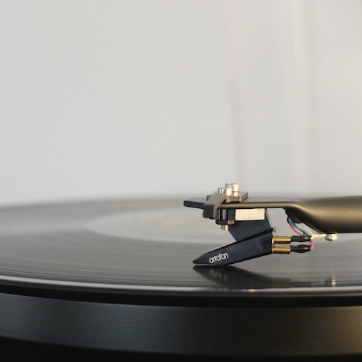 Tonearm resting on a spinning record